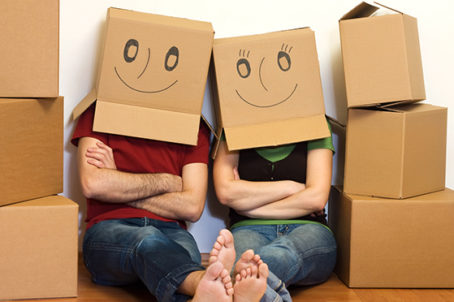 Happy couple in their new home having fun - moving concept
